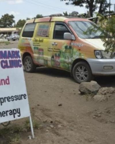 image of van parked outside herbal clinic and acupressure therapy sign
